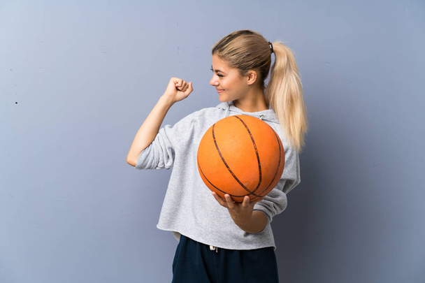 Ragazza adolescente che gioca a basket oltre muro grigio
 - Foto, immagini