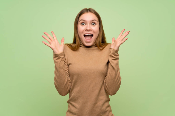 Young woman with turtleneck sweater with shocked facial expression - Photo, Image