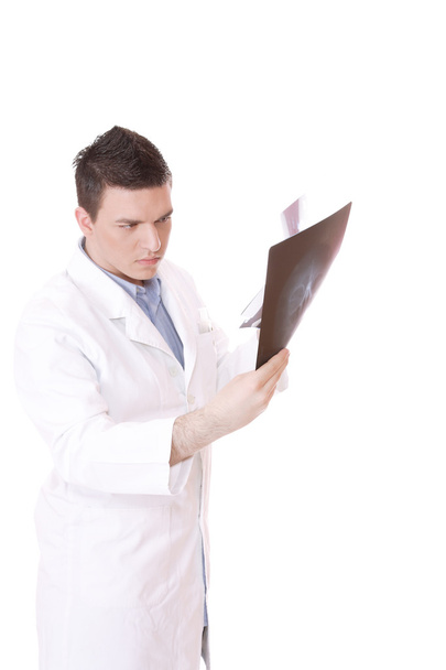 Caucasian doctor holding up xrays - Фото, зображення
