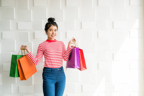 Asian woman holding shopping bags - Photo, Image
