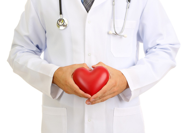 Medical doctor holding heart isolated on white - Foto, afbeelding