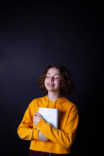 Young caucasian girl holding notebook with Back to School - Fotoğraf, Görsel