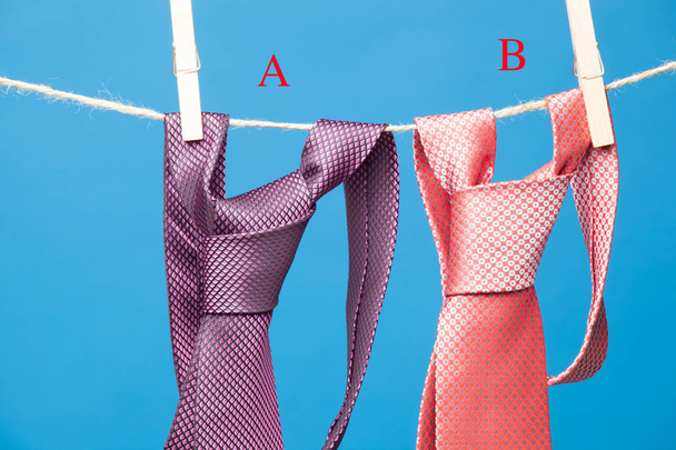 Tie with classic knot, hung on a rope and fastened by wooden clothespins to hang clothes - Photo, Image