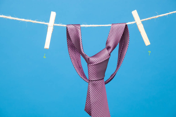 Tie with classic knot, hung on a rope and fastened by wooden clothespins to hang clothes - Fotografie, Obrázek