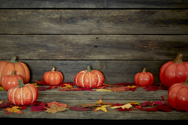 Herbstkürbisse und Blätter auf Holz - Foto, Bild