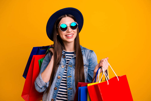 Portrait inspired cute charming nice person shopaholic black friday concept free time vacation positive cheerful satisfied hold hand specs denim jeans outfit youth striped isolated yellow background - Foto, Bild