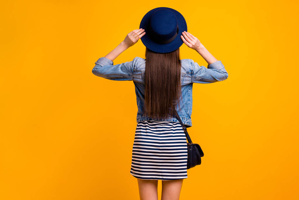 Rear back behind view portrait of her she nice-looking attractive content successful straight-haired lady luxurious brand clothes isolated over bright vivid shine yellow background - 写真・画像