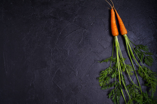Carrots and beetroots  on dark background. Summer vegetable background. Layout, flat lay, copy space - Foto, Bild