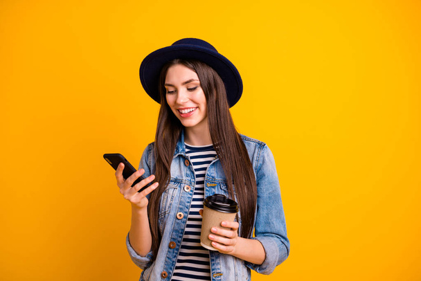 Close-up portrait of her she nice-looking charming cute attractive lovely cheerful cheery straight-haired lady chatting browsing online app isolated over bright vivid shine yellow background - Photo, image