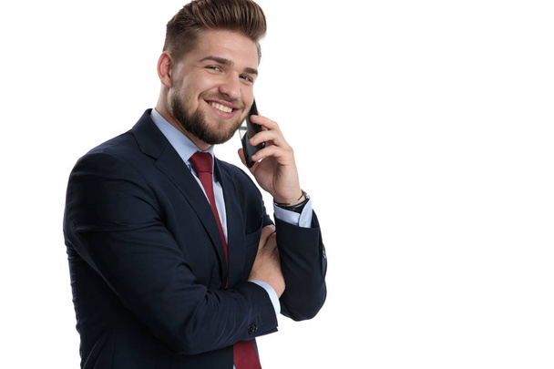 Gelukkige zakenman praat op zijn telefoon en lacht  - Foto, afbeelding