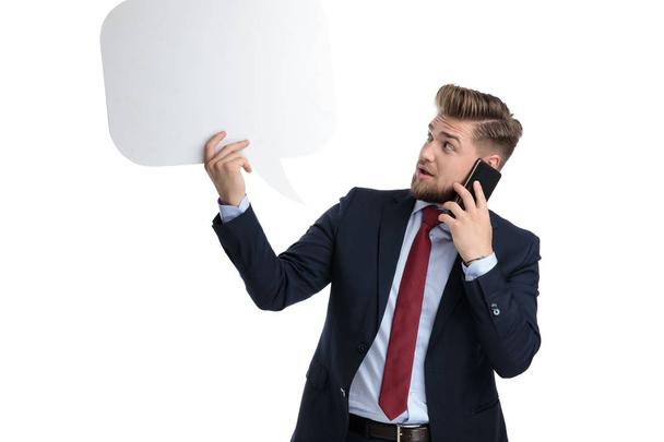 Amazed businessman looking to a blank speech bubble - Photo, Image