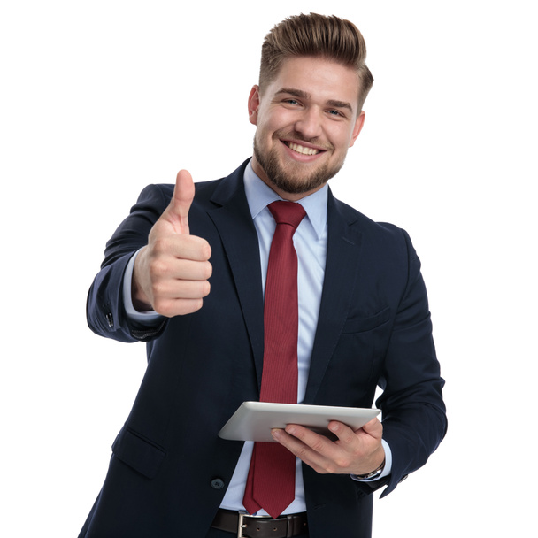 Happy businessman holding a tablet and gesturing ok  - Foto, imagen