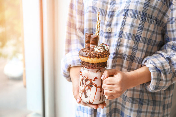 Young woman with delicious freak shake, closeup - Foto, afbeelding