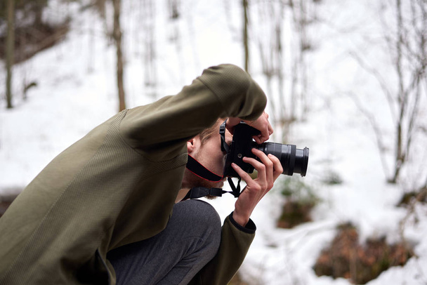 Young blonde adult male taking photos in Bicaz keys - Photo, Image