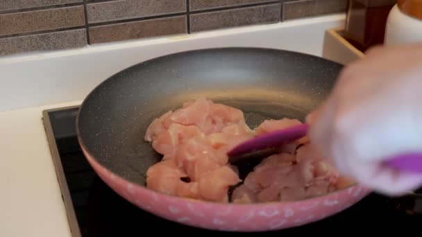 Femme est frire filet de poulet sur une poêle à la maison préparer le déjeuner, mains gros plan
. - Séquence, vidéo