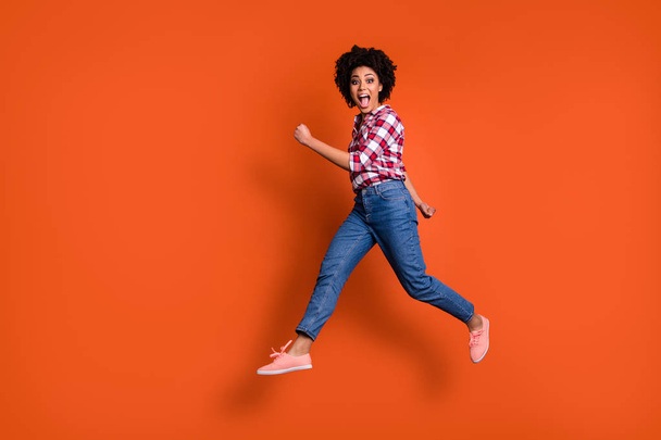 Full body side photo of excited jumping high lady yelling loud sale discount shopping wear casual clothes outfit isolated orange background - 写真・画像