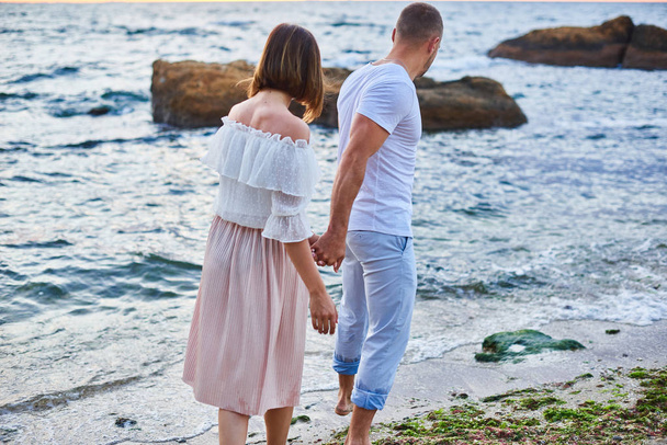 couple in love walks at the beach in ocean shore - Fotó, kép