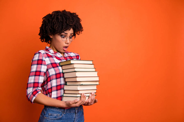 Close up side profile photo beautiful she her model lady oh no expression open mouth hold arms hands many books examination stupor wear casual checkered plaid shirt isolated bright orange background - Fotoğraf, Görsel