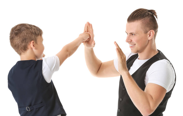 Portrait of father teaching his son to fight on white background - Foto, Imagem