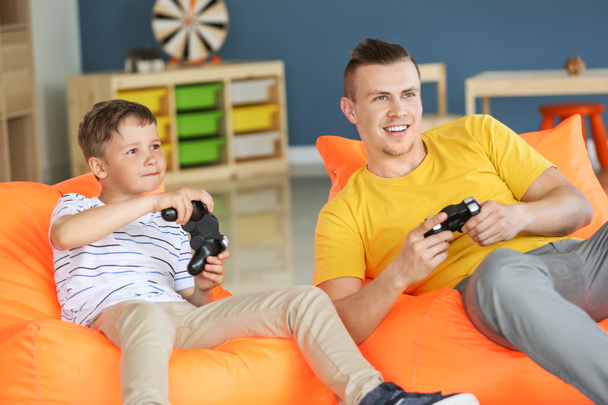Portret ojca i syna grających w gry wideo w domu - Zdjęcie, obraz