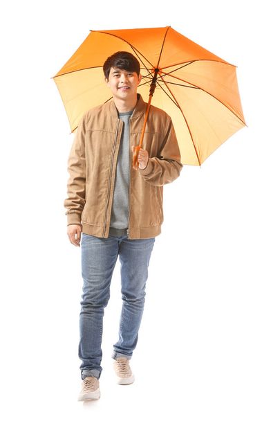 Handsome Asian man with umbrella on white background - Фото, изображение