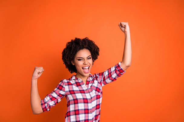 Portrait of her she nice attractive ecstatic excited cheerful cheery satisfied wavy-haired lady wearing checked shirt great attainment isolated over bright vivid shine orange background - Fotoğraf, Görsel