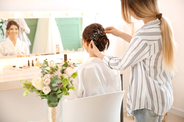 Professional hairdresser working with young bride at home - Photo, Image