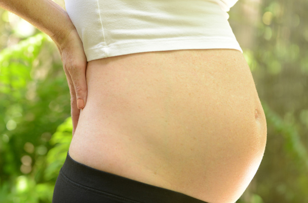 Беременная женщина и боли в спине
 - Фото, изображение