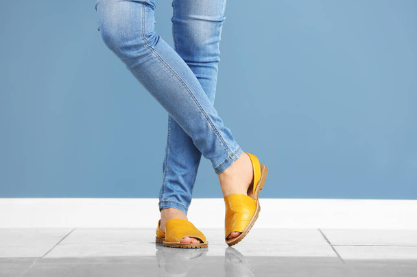 Young woman in stylish shoes against color wall - Photo, Image