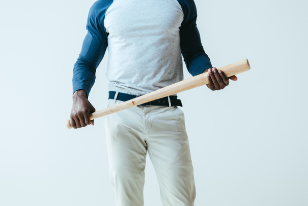 partial view of african american sportsman holding baseball bat isolated on grey - Foto, afbeelding