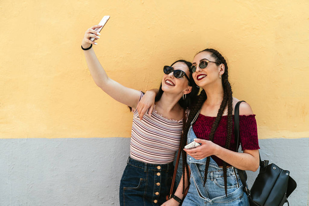 Beautiful woman friends taking a selfie - Photo, image