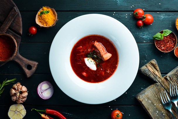 Borsch. Beet soup. Ukrainian cuisine. On a wooden background. Top view. Free space for your text. - Valokuva, kuva