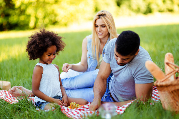 Happy family having fun time together on picnic - Fotoğraf, Görsel