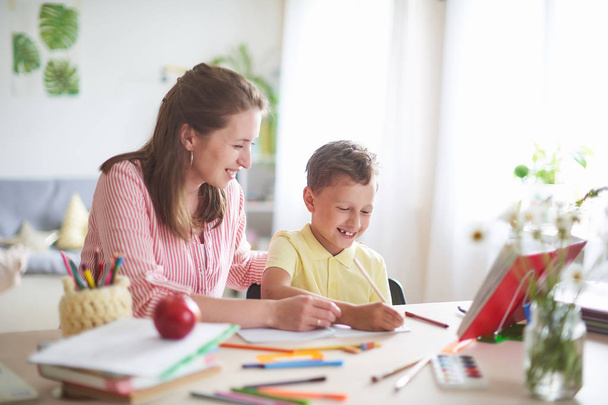 mother helps son to do lessons. home schooling, home lessons. th - Φωτογραφία, εικόνα
