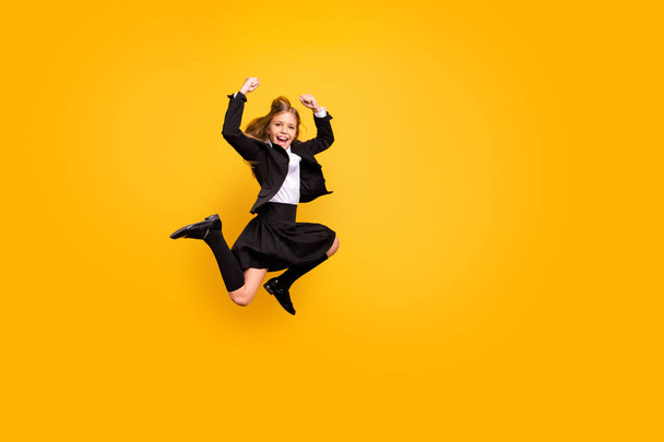 Full length photo of delighted kid screaming shouting yeah rasing fists celebrating isolated over yellow background - Foto, Imagem