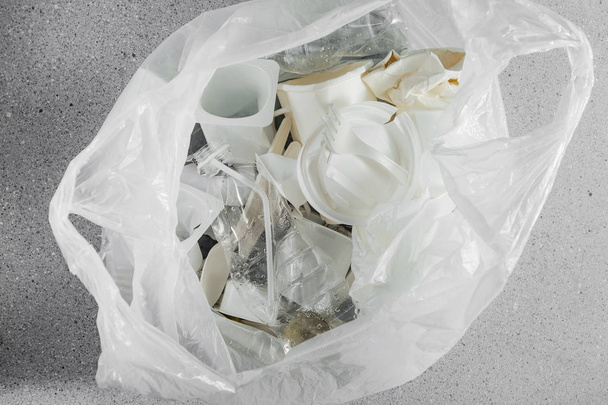 White single use plastic in plastic bag, concept of recycling plastic and ecology - Fotó, kép