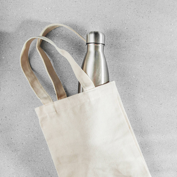 Natural color eco bag with reusable metal water bottle - Photo, image