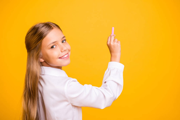 Close-up profile side view portrait of her she nice attractive genius brainy smart clever straight-haired pre-teen girl nerd writing information isolated on bright vivid shine yellow background - Photo, image