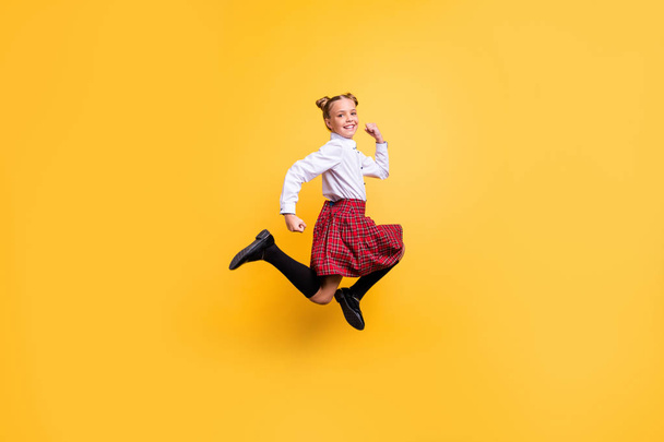 Full length body size view of her she nice lovely attractive cheerful cheery positive careless pre-teen girl having fun time isolated over bright vivid shine yellow background - 写真・画像