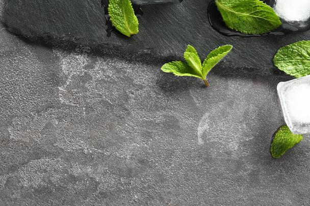 Slate plate, mint and ice cubes on grey background - Foto, immagini