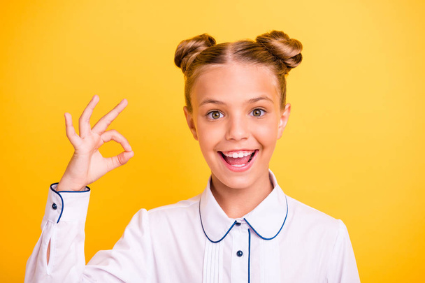 Close-up portrait of her she nice attractive lovely sweet cheerful cheery confident optimistic pre-teen girl wearing white shirt showing ok-sign isolated on bright vivid shine yellow background - Photo, Image