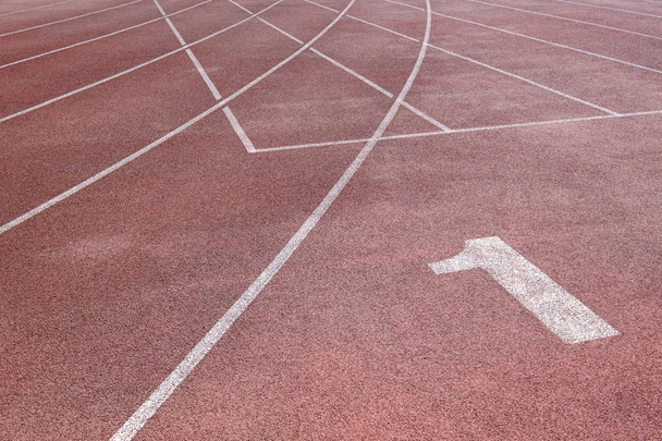 Running track at the stadium with different numbers and white lines - Foto, immagini