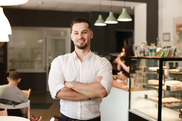 Young caucasian businessman standing with at cafe. - Photo, Image