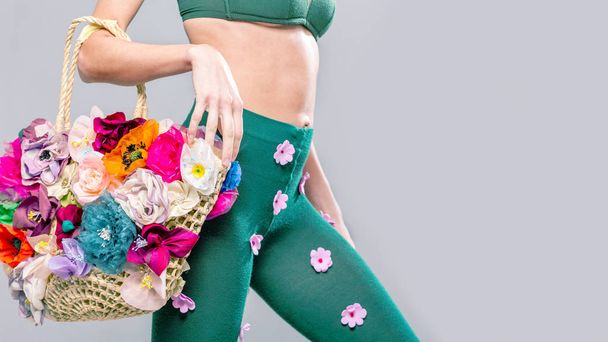 Shopping concept. Beautiful woman wearing funny tights and holding bag  decorated with flowers - Fotografie, Obrázek