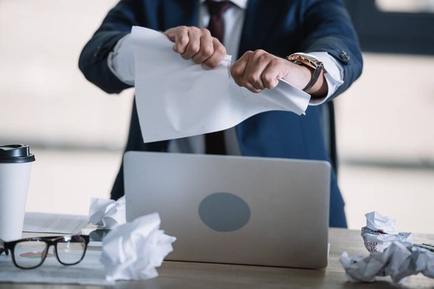 cropped view of businessman tearing paper in office  - Photo, Image