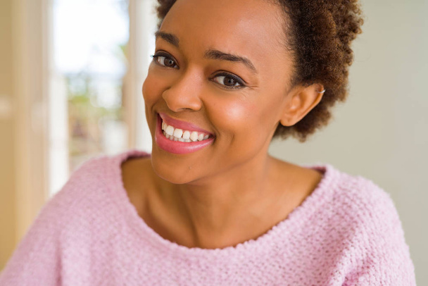 Beautiful young african american woman smiling confident to the  - Photo, Image