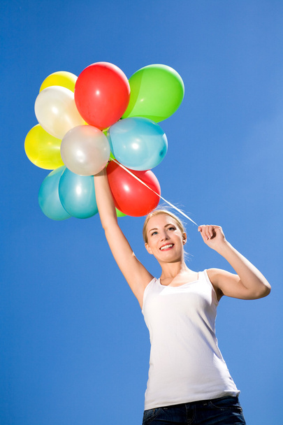 Woman holding bunch of balloons - Foto, afbeelding