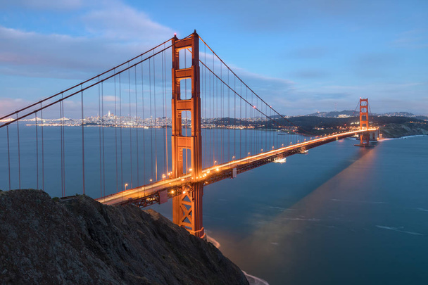 Classic panoramic view of famous Golden Gate Bridge in beautiful evening light on a dusk with blue sky and clouds in summer or autumn, San Francisco, California, USA  - Photo, Image
