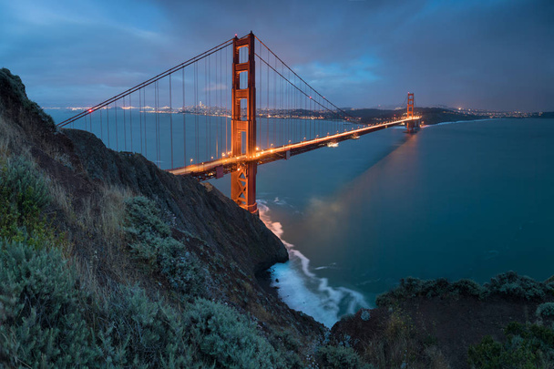 Classic panoramic view of famous Golden Gate Bridge in beautiful evening light on a dusk with blue sky and clouds in summer or autumn, San Francisco, California, USA  - Photo, Image