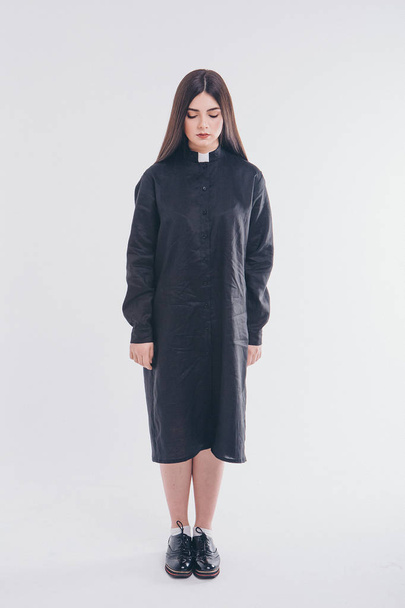 nun on white background. A girl in a black shirt with a white collar. the concept of Church education - Фото, зображення